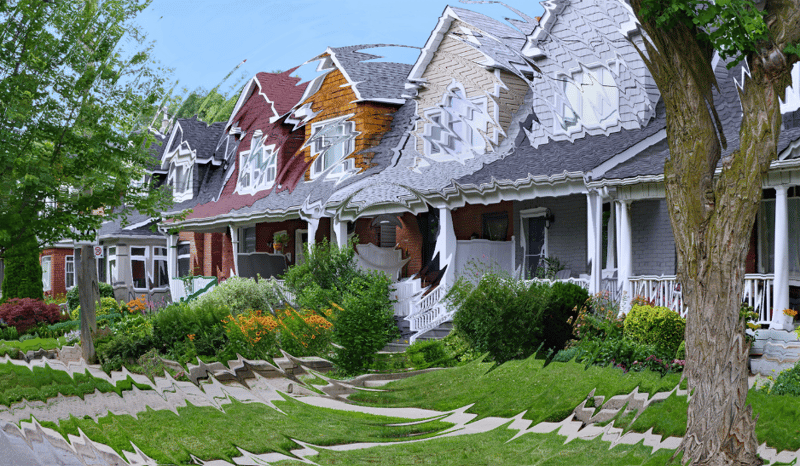 A row of houses with front porches and gardens on a residential street